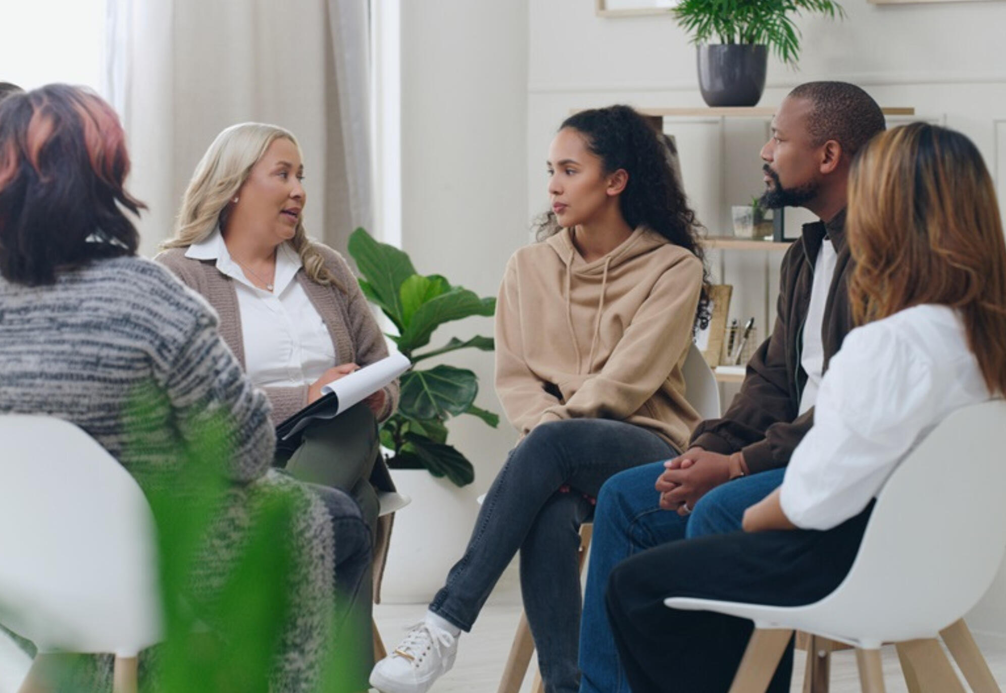 A group of people sitting in a circle talking
