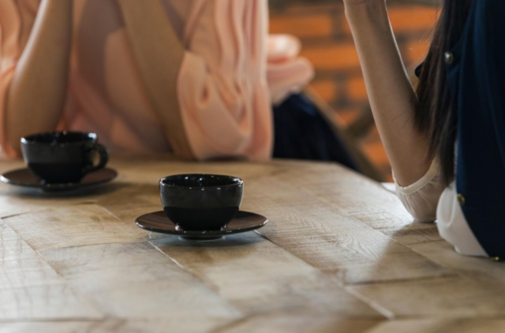 Two women talking over coffee